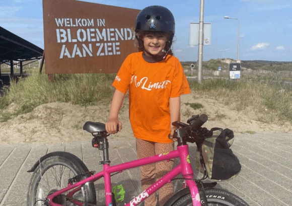 Photo of Rona with her bike in the Netherlands.