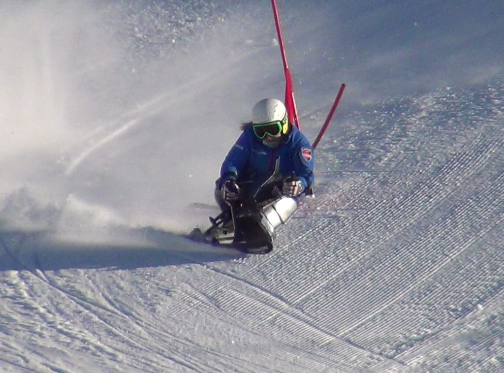 Anna sit skiing around a red pole