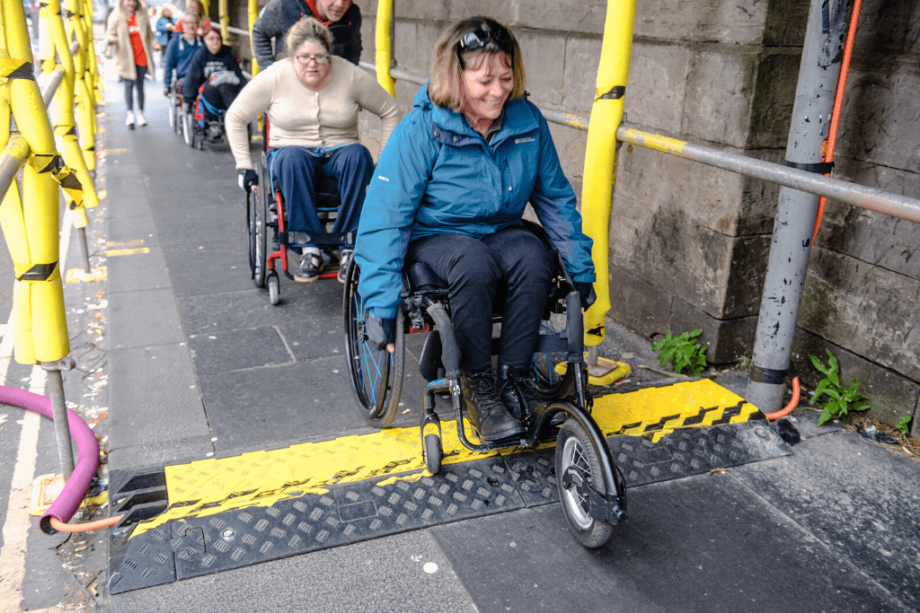 Julie leading a group of participants over a bump on our Edinburgh City skills course 