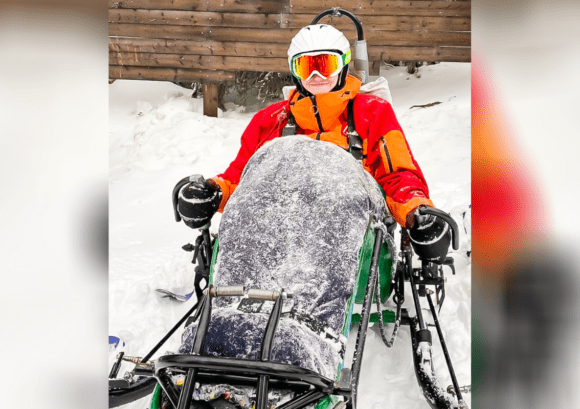 Tess, who we interviewed for our impact report, using a ski kart in sweden