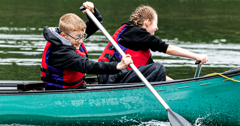 two young people with a spinal cord injury in a canoe