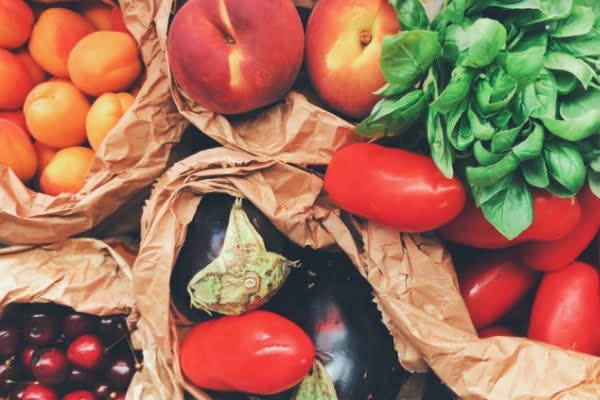 a load of fruit and vegetables arranged on a table