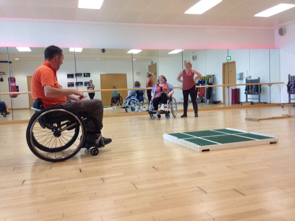 A photo of a wheelchair skills trainer and participant