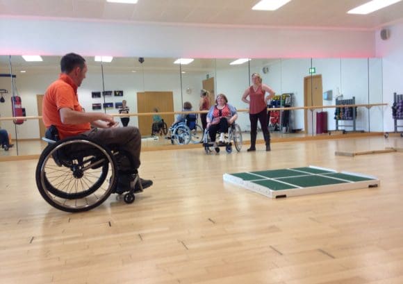 A photo of a wheelchair skills trainer and participant