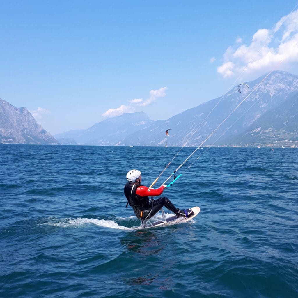 A picture of Alan Grace kitesurfing on a lake