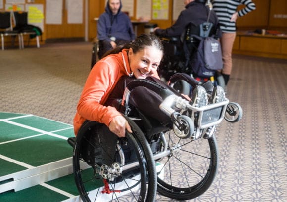 Wheelchair user doing a back wheel balance