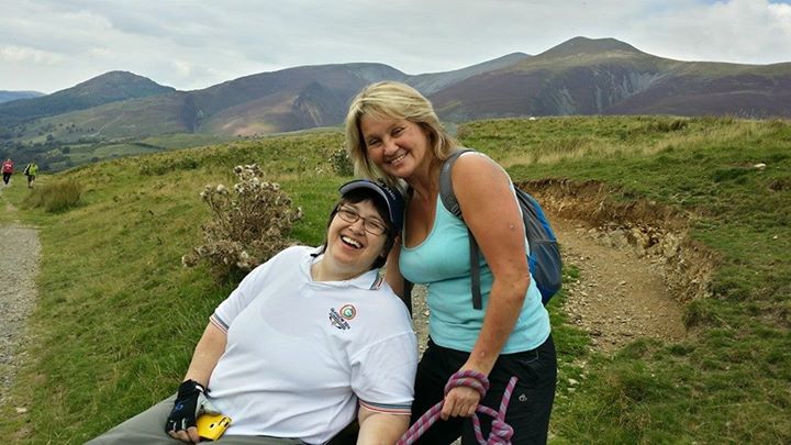 Michelle volunteering as a buddy and smiling with a participant