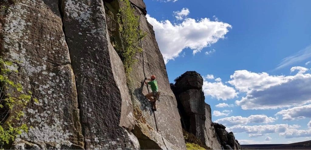 A wide angle photo of Peter climbing