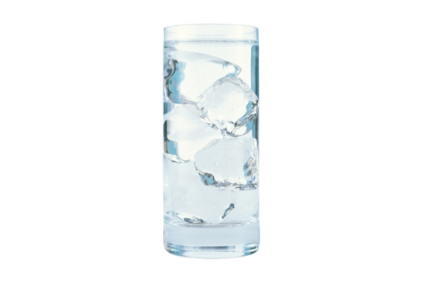 A glass of ice water against a white background